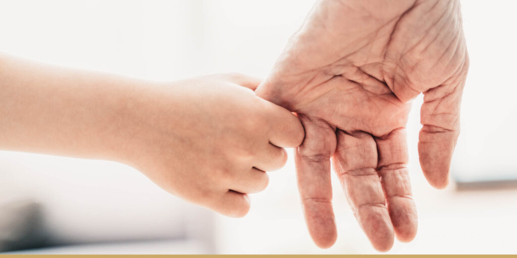 Grandfather and grandchild holding hands