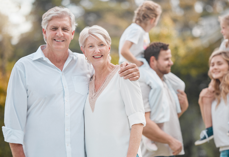Older adults with family members playing outside