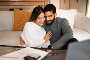 Newlywed couple at home discussing estate planning in New Hampshire